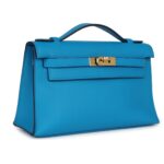 PRE-OWNED HERMÈS KELLY POCHETTE BLEU FRIDA SWIFT GOLD HARDWARE